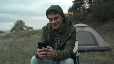 Young man having video call outdoors Stock Footage 319783516