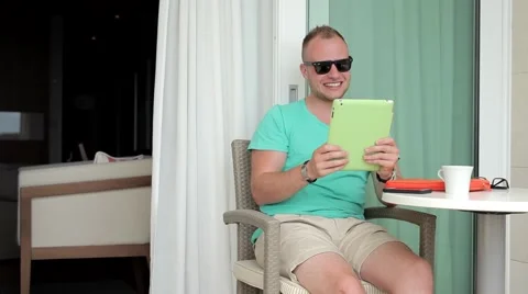 Young man having video conversation through  his tablet pc Stock Footage 53606714