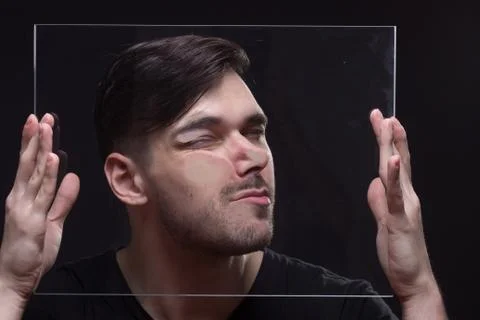 Young man head face pressed against glass Stock Photos
