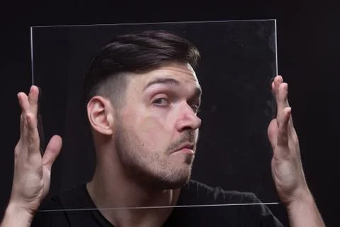 Young man head face pressed against glass Stock Photos