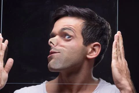 Young man head face pressed against glass Stock Photos