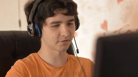 Young man in headphones with computer Stock Footage 77101767