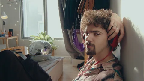 Young Man in Headphones Looking at Camera in Bedroom Stock Footage 235659490