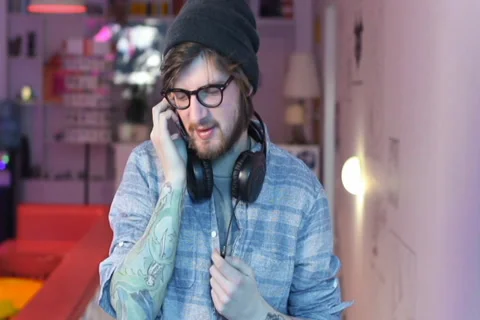 Young man in headphones talking mobile phone laughing smiling Stock Footage 35995553