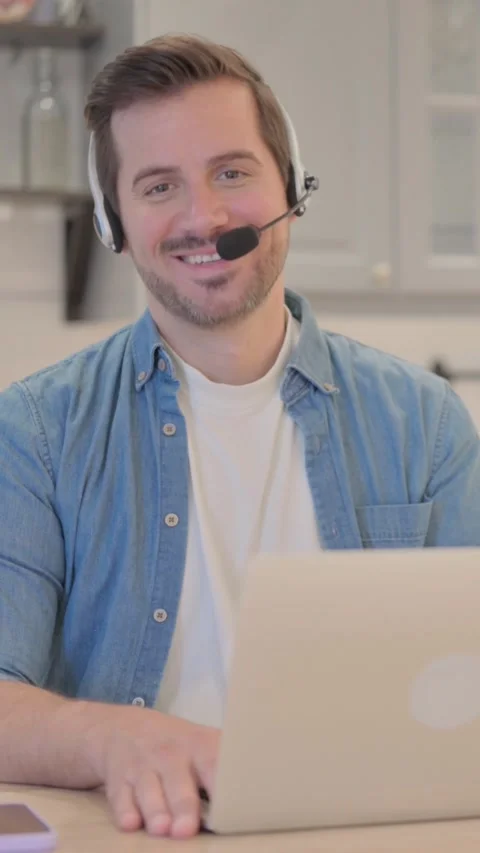 Young Man with Headset Smiling at Camera in Call Center, vertical video 库存影片 328565873