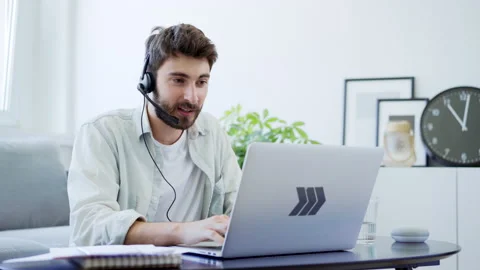 Young man with headset talking during video call working from home 動画素材 142537024