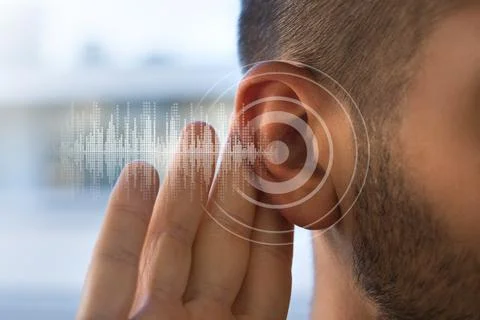 Young man with hearing problems or hearing loss. Hearing test concept. Stock Photos
