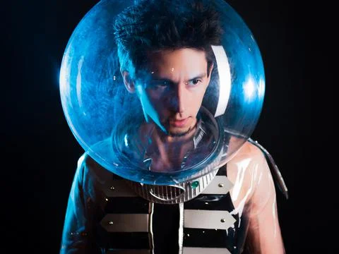 A young man in a helmet, a protective bubble. image in style of retro-futurism. Stock Photos