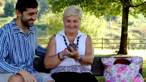 Young man help senior technology by Josu Ozkaritz Stock Footage 165052192