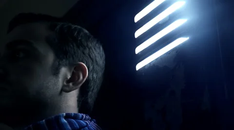 Young man hidden in a basement Stock Footage 68938769