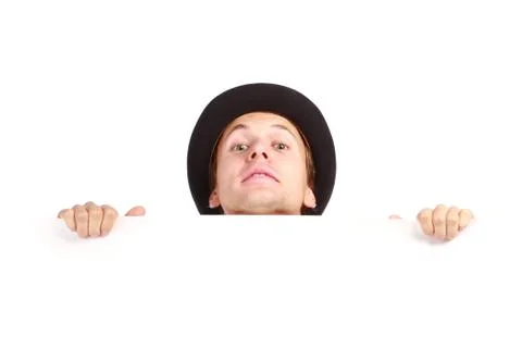 Young man hiding behind Foto stock