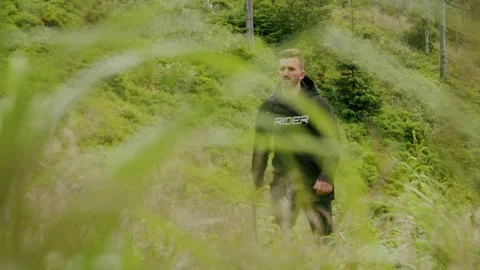 Young man hiking in the forest, walking in nature 4K. Stock Footage 234558894