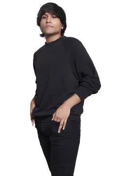A young man in his 20s posing for the camera, he is wearing a black T-shirt and Stock Photos