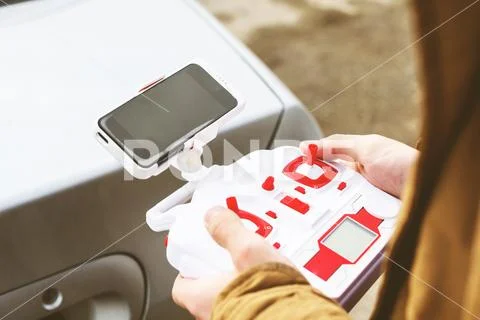 The young man is holding a control panel for the drones-quadrocopter Stock Photos