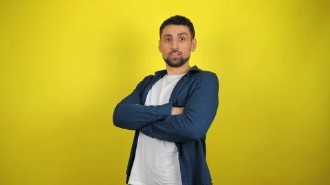A young man holding hands folded, turns to camera and says what Stock Footage 119860088