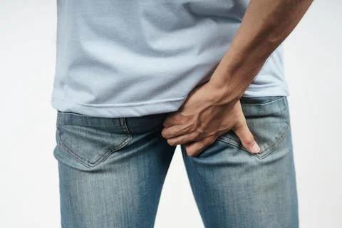 Young Man holding his bottom because Diarrhea, Hemorrhoids, constipation. H.. Stock Photos