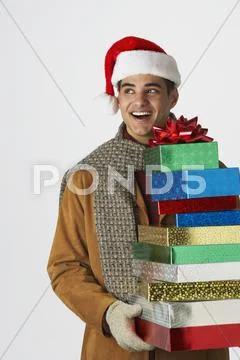 Young man holding holiday gifts Stock Photos