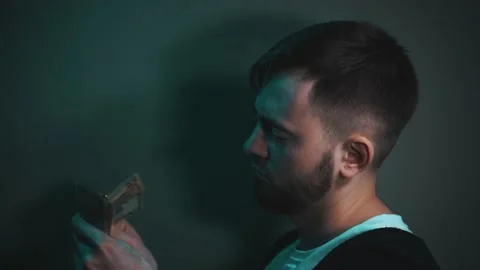 Young man holding an impressive amount of dollar bills in his hands Vidéo 147463772