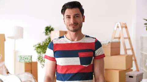 Young man holding key ring to his new house   Video stock 112164063