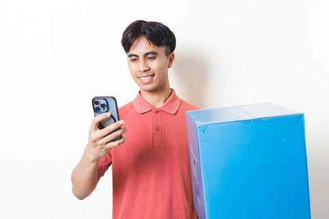 Young man holding a large package while checking his smartphone, illustrati.. Stock Photos