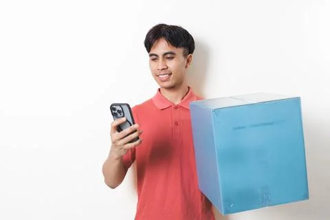 Young man holding a large package while checking his smartphone, illustrati.. Stock Photos