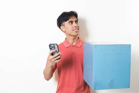 Young man holding a large package while checking his smartphone, illustrati.. Stock Photos
