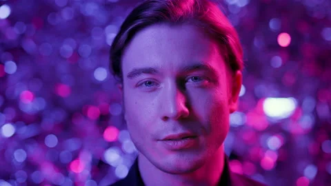 Young Man Holding Large Shiny Layer. He Is In Nightclub. Stock Footage 178596154