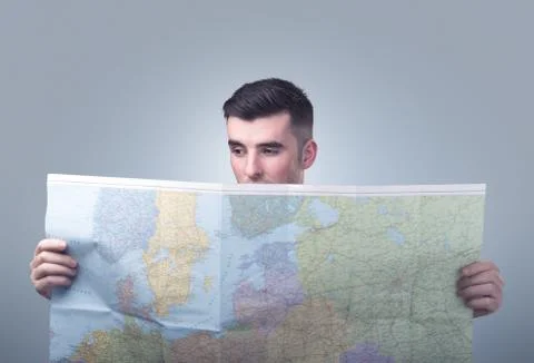 Young man holding map Stock Photos