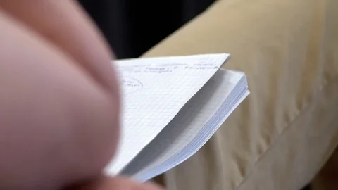 Young man holding a notebook on his lap and listening to a lecture Stock Footage 76244294