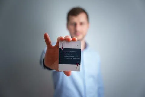 Young man holding a programming cards in his hand. Stock Photos