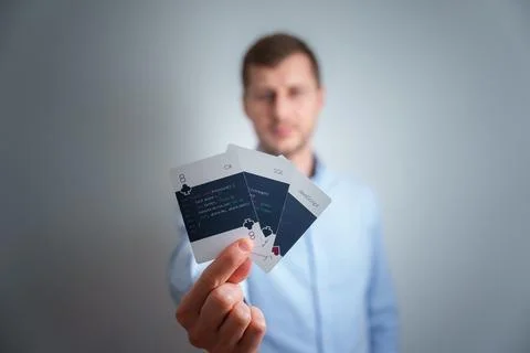 Young man holding a programming cards in his hand. Stock Photos