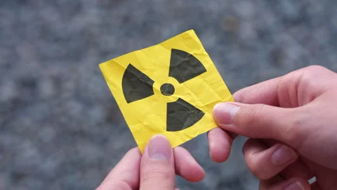 A young man holding a radiation warning sign in his hands. Stock Footage 317941932