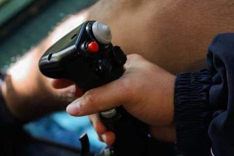 Young man holding a red-buttoned game controller in his hands Stock Photos