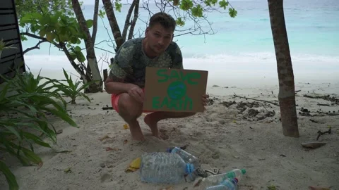 A young man holding a "Save the Earth" Stock Footage 146752030