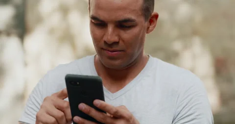 Young Man Holding Smartphone Device in Hands and Texting Message in Barcelona Stock-Footage 148348540