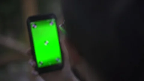Young Man Holding Smartphone with empty green screen, outdoors 動画素材 89984793