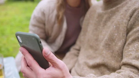 A young man holds a smartphone in his hands, he and his wife lead a vlog from Stock Footage 145532030