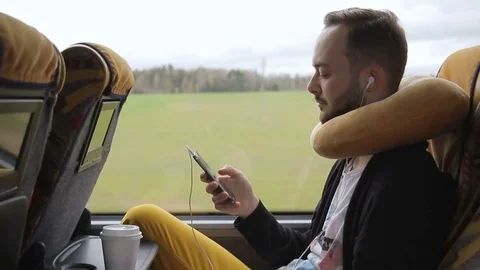 Young man holds smartphone while traveling by bus in afternoon. Video stock 83151360