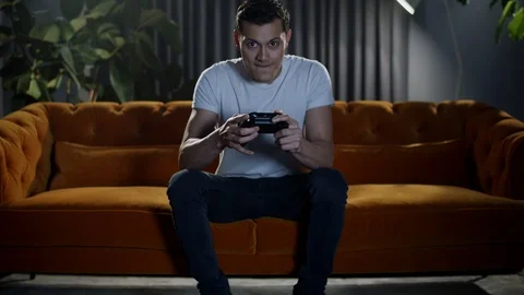 Young man at home playing an intense online video game with skill and expertise. Stock Footage 100172329