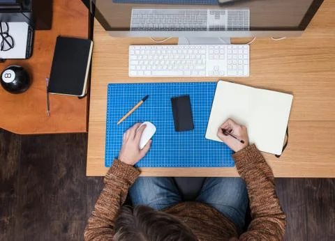 Young man at home using a computer, freelance developer or designer working Stock Photos