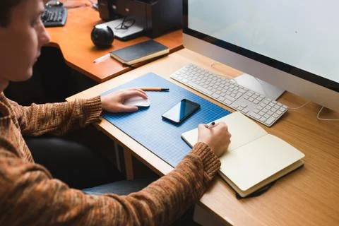 Young man at home using a computer, freelance developer or designer working Stock Photos