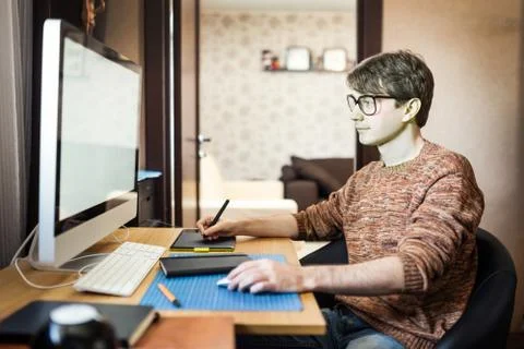 Young man at home using a computer, freelance developer or desig Foto stock
