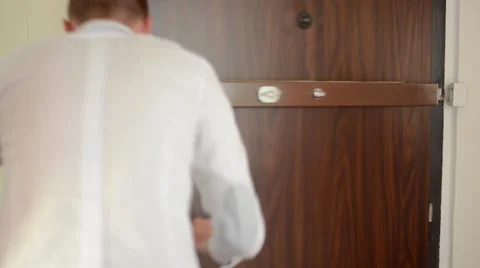 Young man hurries out from the flat Stock Footage 51671106