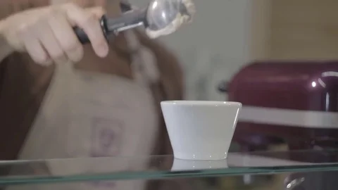 Young man, imposes, squeezes ice cream from a spoon into a glass, a ball, a cook Stock Footage 74869029