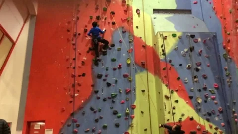 Young man Indoor Wall Climbing Stock Footage 144270320