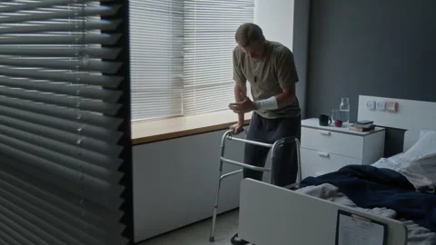 Young Man with Injury Using Walker for Rehabilitation Stock Footage 340636893