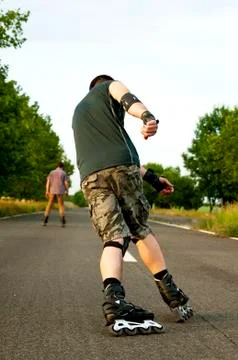 Young man with inline skates in summer Stock Photos