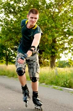 Young man with inline skates in summer Stock Photos