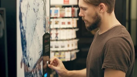 Young Man Inserting Coin into Vending Machine Stock Footage 117254767