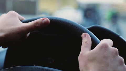Young man inside car. Close up of hands on steering wheel. Driving car fast and Stock Footage 131515837
